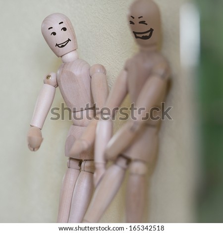 Wooden people standing at home and chatting. People relationship concept. Drawn faces