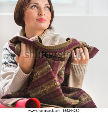 Portrait of a woman preparing to her husband or boyfriend surprise with a gift on his birthday or christmas or valentine\'s day or another holiday