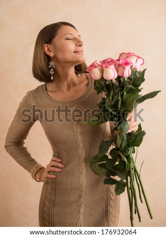 Beautiful woman with a large bouquet of flowers in her arms