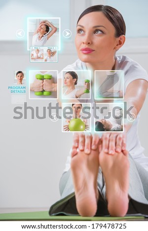 Sporty woman working out using modern virtual interface. Online fitness trainer concept
