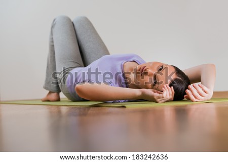 The young beautiful girl relaxing during doing exercises at home or gym