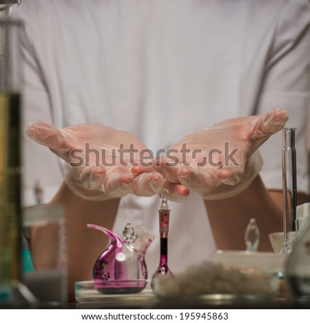 Chemical laboratory scene: unrecognizable PhD student scientist presenting and showing copy space for product