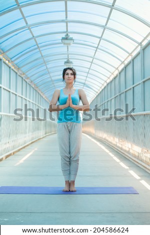 Young mixed woman in the prayer position. Full Length