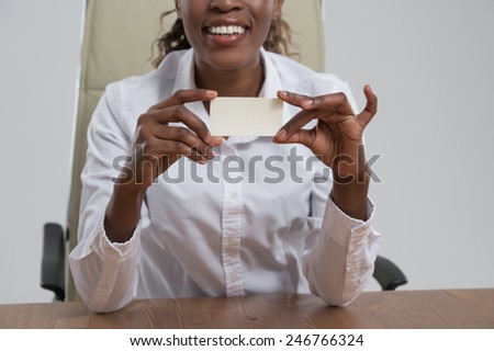 African Businesswoman showing and handing a blank business card. Business woman at workplace at office