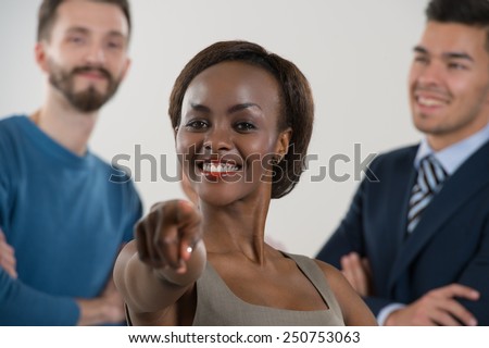 Group of friendly businesspeople with female leader in front