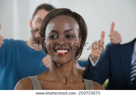 Image of African-American female business leader in front of her business team