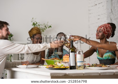Multiracial Group Of Young Friends Enjoying Meal at Home