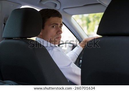 The young man behind the wheel driving car