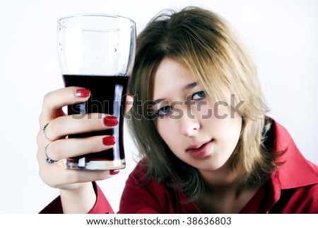 Studio portrait of a beautiful young woman, giving us drink in pure glass, isolated on white background