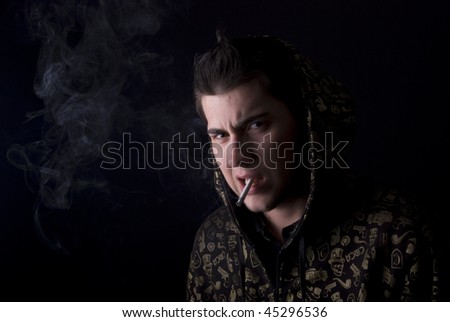 Portrait of a cool guy: smoking a cigarette