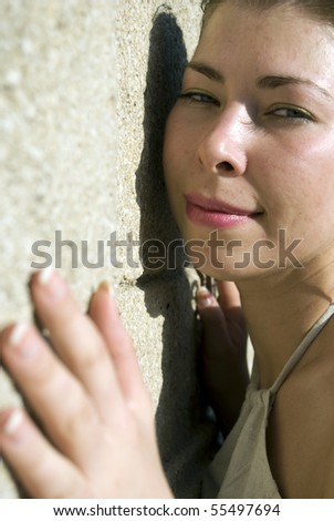 Young woman against wall