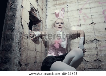 Young sexy trash woman posing inside abandoned vintage building