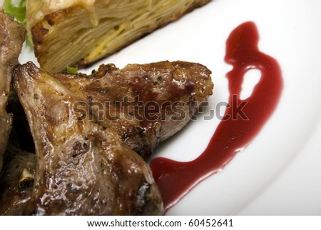 Grilled meat with cake on white plate