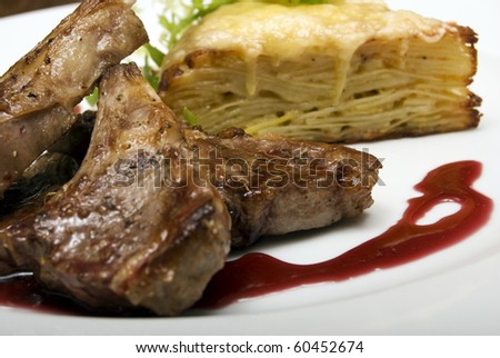 Grilled meat with cake on white plate