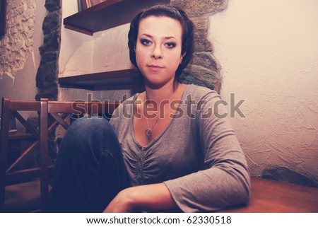 Portrait of young attractive emotional woman sitting in cafe and telling her sad story