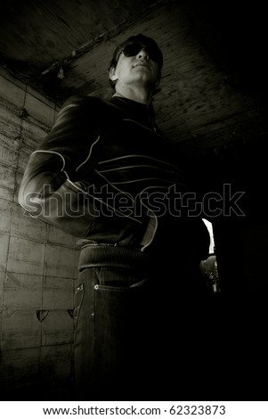 Portrait of young man inside abandoned building against vintage wall