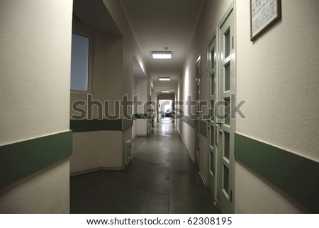 Long corridor in hospital with doors and chairs
