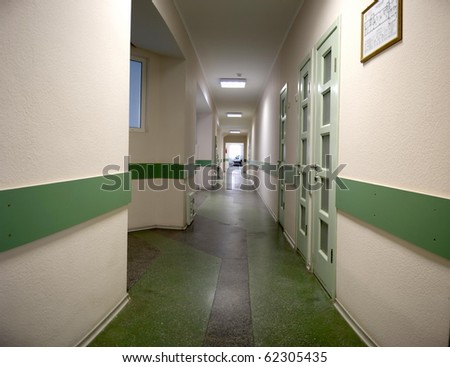 Long corridor in hospital with doors and chairs
