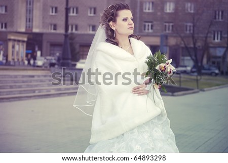 Portrait of young attractive fit bride outdoor with beautiful lily bouquet