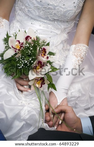 closeup of important moment when groom putting on the ring on the finger of his bride