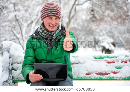 Freedom - Man using a laptop outdoor in winter park with copyspace