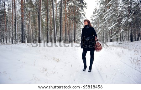 Portrait of young beautiful woman outdoor - lost in the forest and dreaming about something