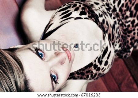 Portrait of pretty young woman laying on stairs at home and posing