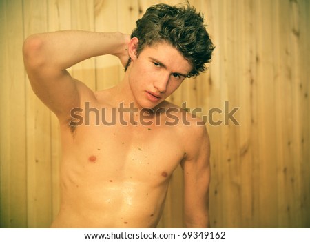 Portrait of young attractive guy resting in hot sauna