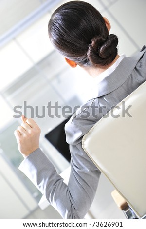 Closeup portrait of cute young business woman from behind