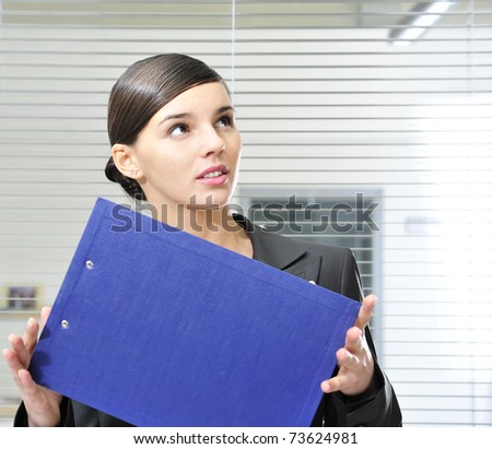 business woman holding reports inside office building. Copy space
