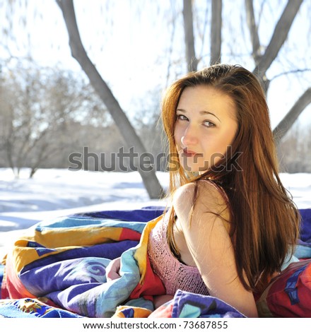 Young woman in her bed in morning outdoor in park. Fresh air inside home concept.