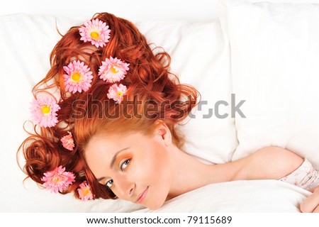 Fashion photo of beautiful nude woman with magnificent hair and flowers