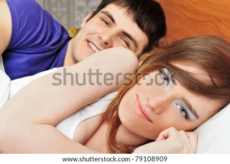 Young man and woman in bed. Couple.