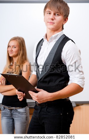 Portrait of college students making presentation of their project in classroom