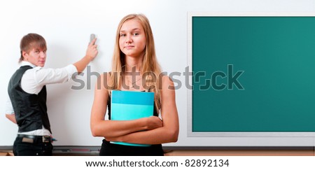 Two students - girl and boy making presentation at classroom