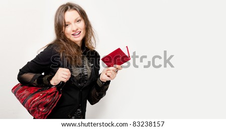 Portrait of a bright beautiful young woman with fashion handbag. Lots of copyspace