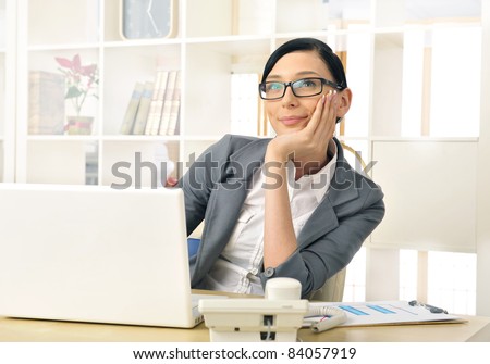 Portrait of a beautiful young businesswoman thinking. Office background.