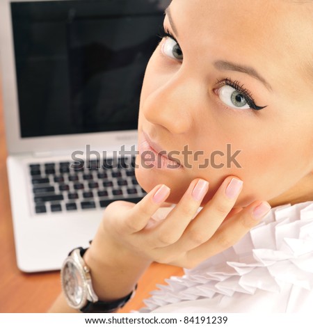 Young business woman on a laptop from behind