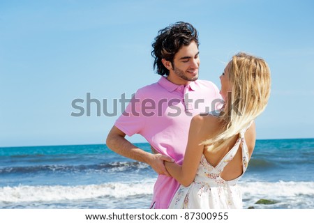 Young couple at beach, embracing, side view. Natural emotions. Happy life