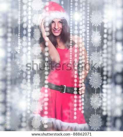 20-25 years od beautiful woman in christmas dress dancing around snowflakes decorations indoor