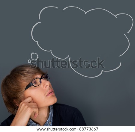 Image of young man thinking of his plans. Lots of copyspace inside graphic cloud for your text