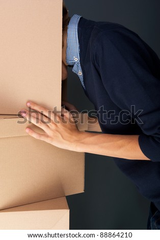 Portrait of anonymous young man with his head inside box