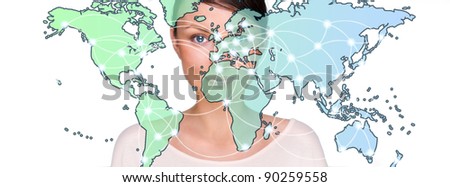 Attractive brunette young woman in futuristic interface standing in front of world map with glowing hot points location and connection lines.