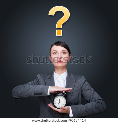 Dark picture of woman holding alarm clock against grey background. Question symbol overhead