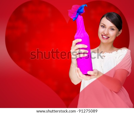 Portrait of young pretty woman holding bottle of prefect wine in gift decorative package against love valentine background with heart shape