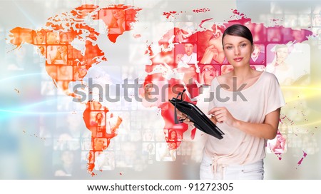 Portrait of young woman holding her tablet computer and communicating with her friends across the world. Standing against world map with photo of people. International communications concept