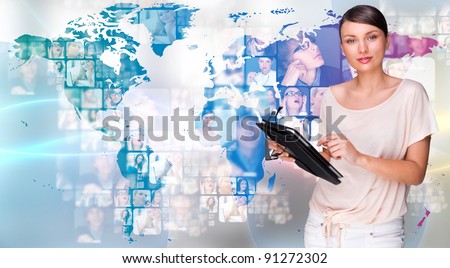 Portrait of young woman holding her tablet computer and communicating with her friends across the world. Standing against world map with photo of people. International communications concept