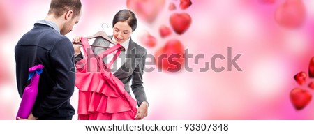 Portrait of adult business man and woman preparing to corporate party. Man gifting cute dress and wine to his colleague. Office romance concept. Romantic background with graphic hearts