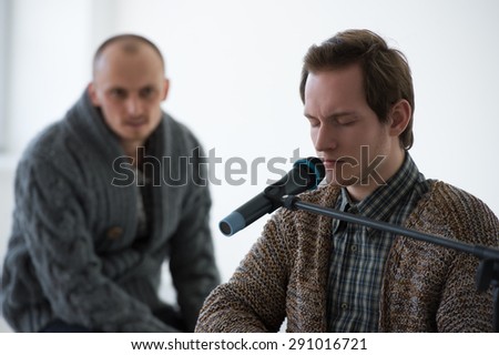 Disabled man on a meeting. Speaking with microphone to public