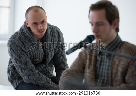 Disabled man on a meeting. Speaking with microphone to public